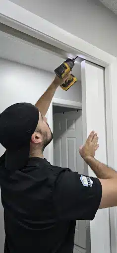 Professional technician working on pocket door- no wall damage