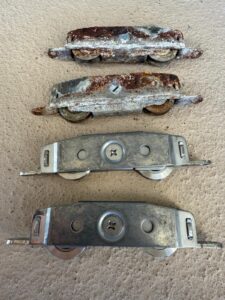 worn sliding door rollers removed during repair