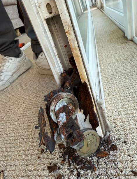 Corroded sliding door roller before repair
