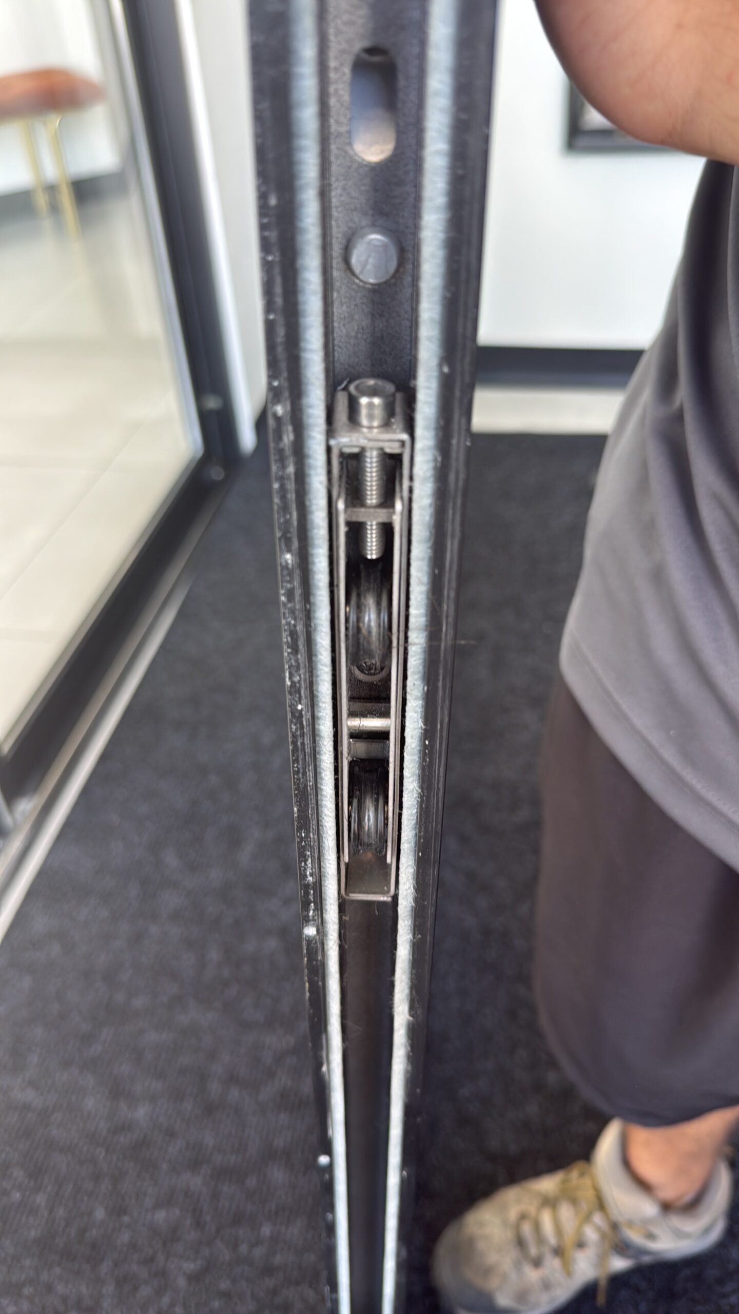 Alpha Sliding Doors technician replacing sliding door rollers on a Florida coastal home